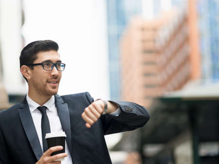 Portrait of young handsome businessman outdoor waiting for someoneの写真素材