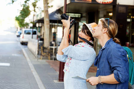 Smiling couple of tourists with the cameraの写真素材