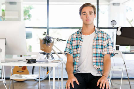 Young man in casual clothes in an officeの写真素材