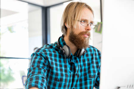Young man in casual clothes in an office