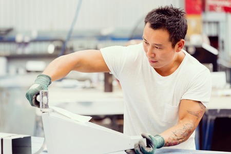 portrait of asian worker in production plant working on the factory floorの写真素材