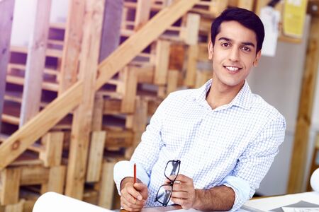 Young man in casual clothes in an office with drafts