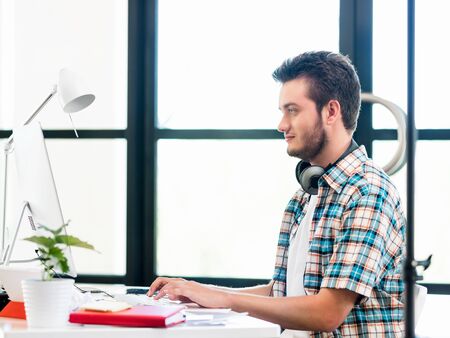 Young man in casual clothes in an office