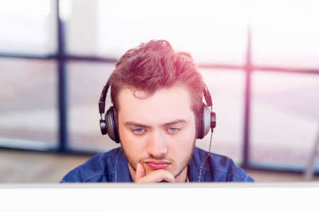 Young man in casual clothes in an officeの写真素材