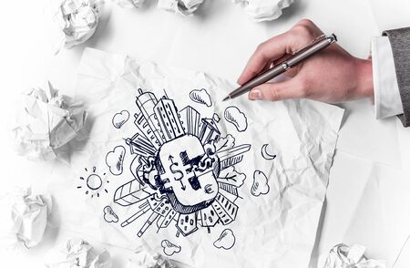 Financial growth concept with hand drawing money signs on paper sheetsの写真素材