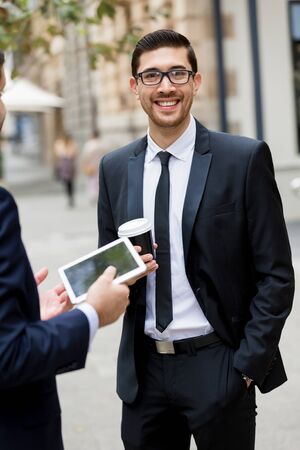 Portrait of young handsome businessman outdoorの写真素材