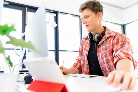 Young man in casual clothes in an office