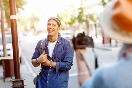 Smiling couple of tourists with the cameraの写真素材