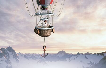 Man in cylinder flying in aerostat high in skyの写真素材