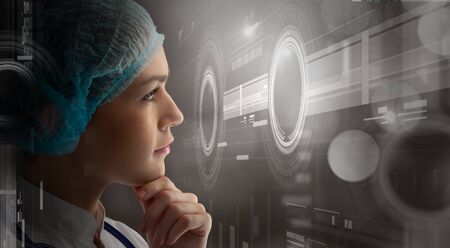 Young female doctor and new media technologiesの写真素材