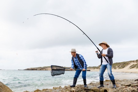 Picture of fishermen fishing with rodsの写真素材
