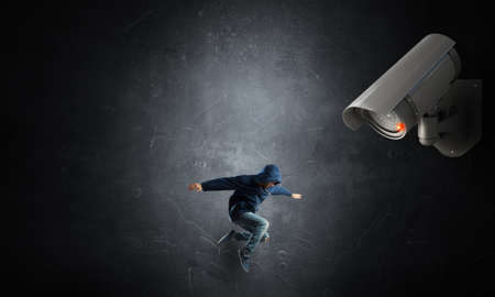 Young dancer man under eye of cctvの写真素材