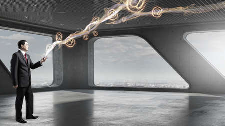 Senior businessman in office interior use tablet pc. Mixed mediaの写真素材