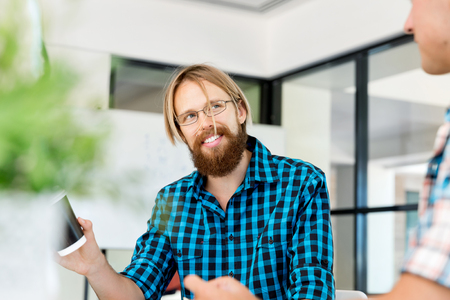 Young man in casual clothes in an officeの写真素材