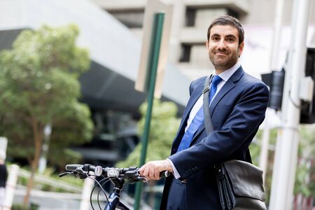 Young businessman with bike outdoorsの写真素材