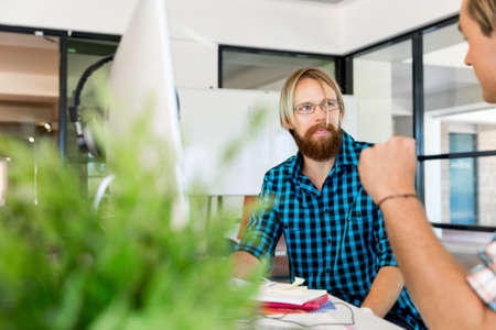 Young man in casual clothes in an officeの写真素材