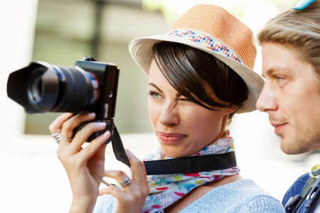 Smiling couple of tourists with the camera