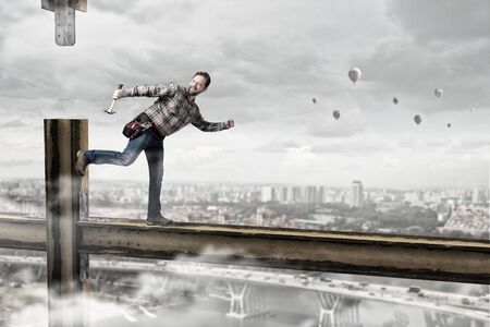 Builder man in checked shirt with tool belt on waistの写真素材