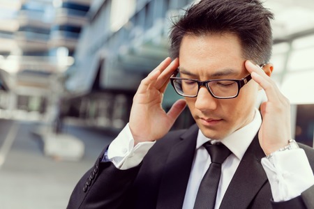 Businessman standing in street and trying to concentrateの写真素材