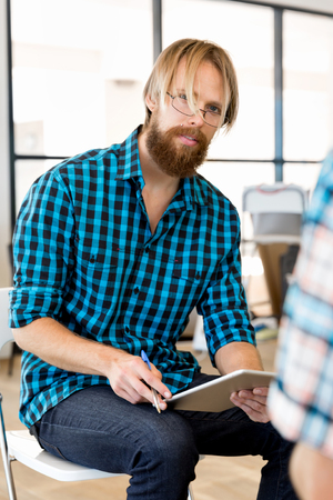 Young man in casual clothes in an officeの写真素材