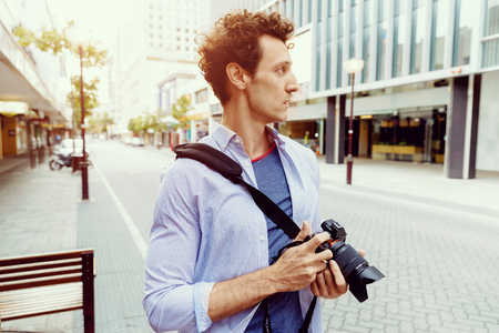 Professional photographer taking picture in cityの写真素材