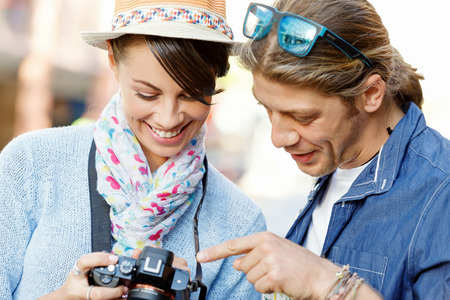 Smiling couple of tourists with the cameraの写真素材