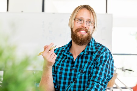 Young man in casual clothes in an officeの写真素材