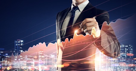 Close view of businessman drawing on screen market infographs . Mixed mediaの写真素材