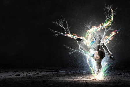 Young cheerful businessman dancing to celebrate his successの写真素材