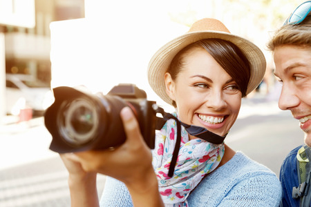 Smiling couple of tourists with the cameraの写真素材
