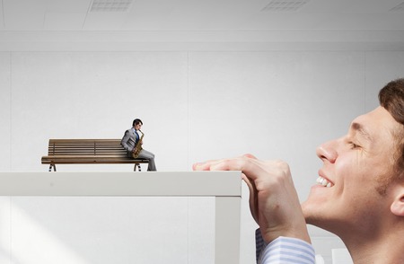 Saxophonist playing his melody while sitting on wooden bench. Mixed mediaの写真素材