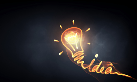 Idea concept with light bulb drawn on dark backgroundの写真素材