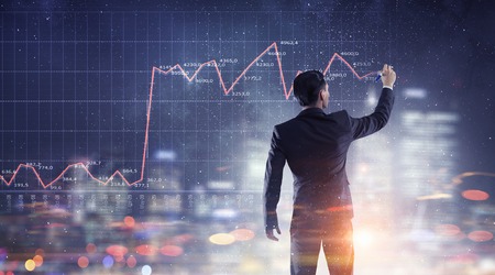 Businessman working on virtual panel with digital infographsの写真素材