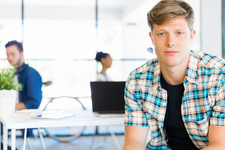 Young man in casual clothes in an officeの写真素材