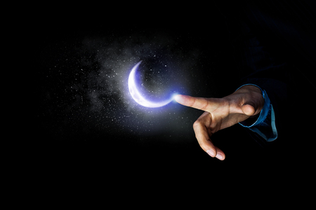 Close of male hand touching with finger moon planetの写真素材