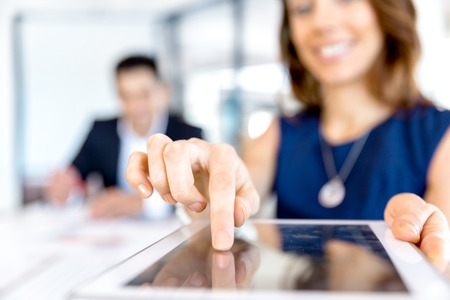 Young business woman in office using tabletの写真素材