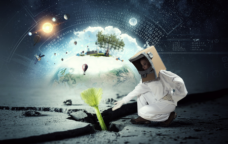 Attractive young woman wearing helmet and astronaut costume. Elements of this image are furnished byの写真素材