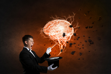 Man magician with cylinder hat doing tricksの写真素材