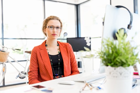Young woman in casual clothes in an officeの写真素材