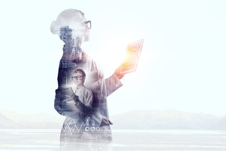 Young woman scientist using tablet pc in her handsの写真素材