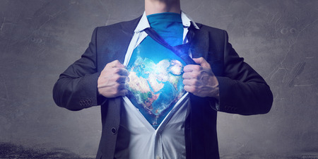 Businessman in classic pose tearing his shirt on chest.の写真素材