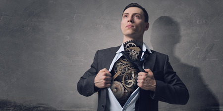 Businessman in classic pose tearing his shirt on chestの写真素材