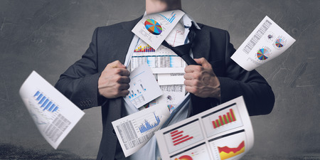 Businessman in classic pose tearing his shirt on chestの写真素材