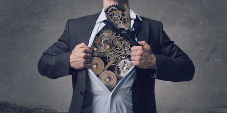 Businessman in classic pose tearing his shirt on chestの写真素材