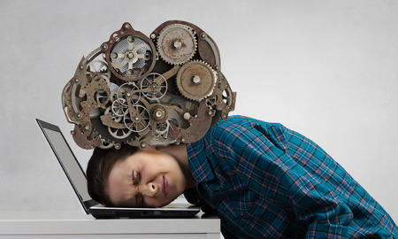 Stressed woman with head under pressure of mechanismの写真素材