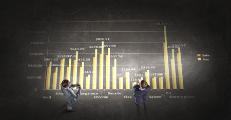 Top view of business people in formalwear standing on infographsの写真素材