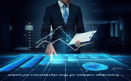 Man pressing technology smart table interface with blue infographsの写真素材