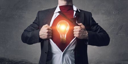 Businessman in classic pose tearing his shirt on chestの写真素材