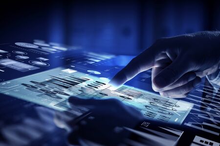 Close up of businessman touching virtual panel with finger