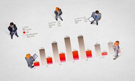 Top view of business people in formalwear standing on infographsの写真素材